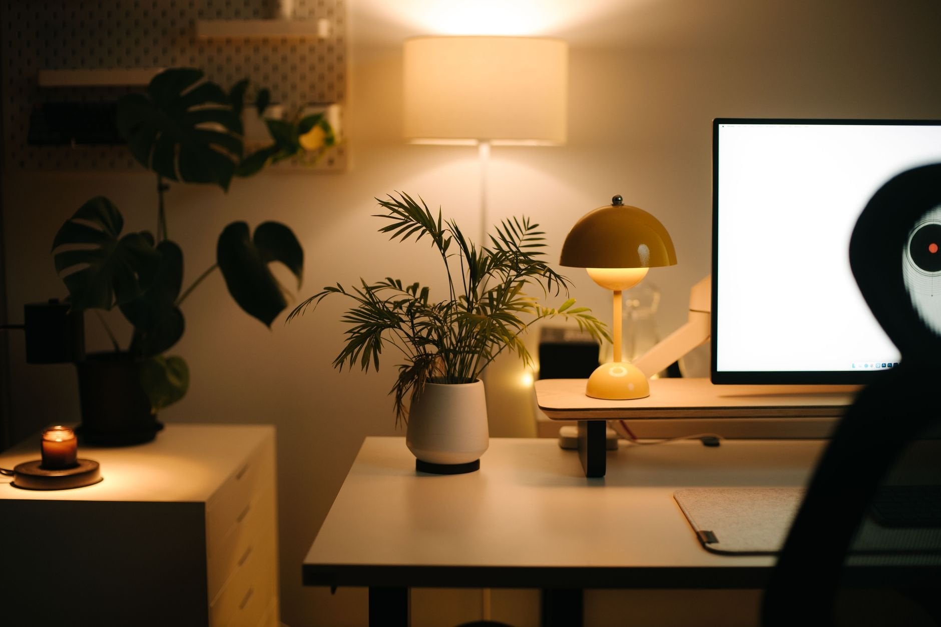 Warm cozy home office setup with ambient lighting and plants — the kind of space KETTLEKNIT is made for